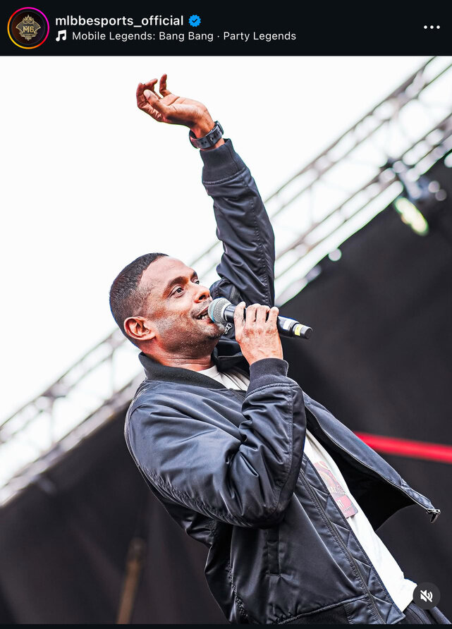 Adam performing on an outdoor stage